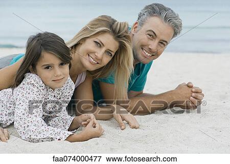 Family lying on beach, portrait View Large Photo Image Stock Photo - Family lying on beach, portrait. Fotosearch
