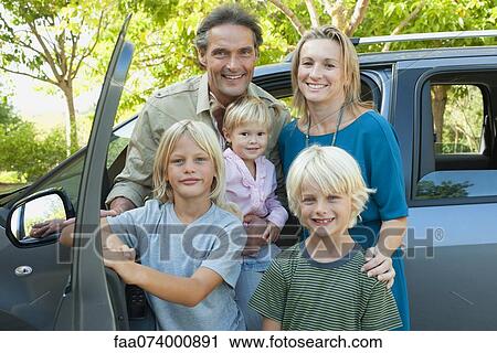 Family posing beside car, portrait View Large Photo Image Stock Image - Family posing beside car, portrait. Fotosearch