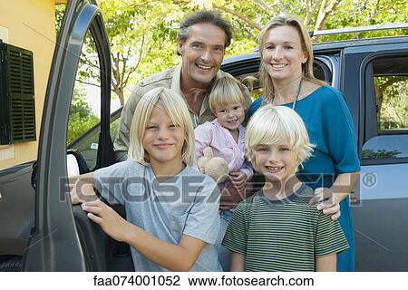 Family posing beside car, portrait View Large Photo Image Stock Image - Family posing beside car, portrait. Fotosearch