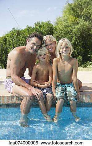 Family relaxing together at poolside, portrait View Large Photo Image Stock Photograph - Family relaxing together at poolside, portrait. Fotosearch