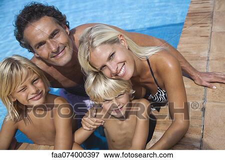 Family relaxing together in swimming pool, portrait View Large Photo Image Stock Photo - Family relaxing together in swimming pool, portrait. Fotosearch
