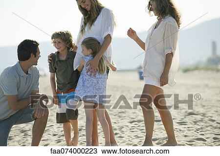 Stock Image - Family spending time together at the beach. Fotosearch