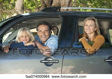 Family together in car, leaning out windows and smiling at camera View Large Photo Image Picture - Family together in car, leaning out windows and smiling at camera. Fotosearch