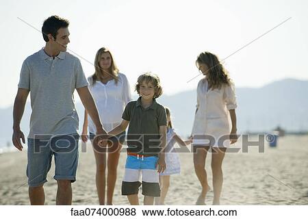 Family walking together at the beach View Large Photo Image Stock Photo - Family walking together at the beach. Fotosearch