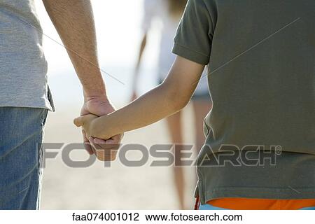 Father and son holding hands, cropped View Large Photo Image Stock Image - Father and son holding hands, cropped. Fotosearch