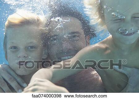 Father and sons swimming underwater View Large Photo Image Stock Photo - Father and sons swimming underwater. Fotosearch