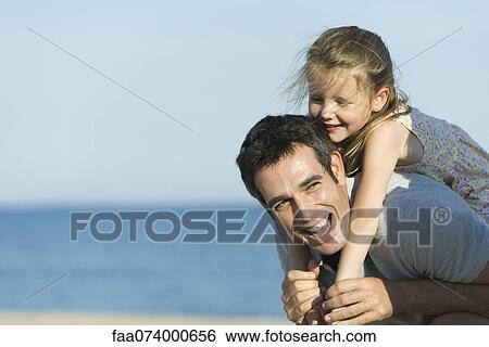 Father giving young daughter piggyback ride View Large Photo Image Stock Photograph - Father giving young daughter piggyback ride. Fotosearch