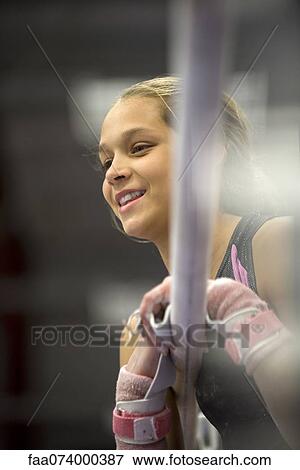 Female gymnast leaning against horizontal bar, portrait View Large Photo Image Stock Photo - Female gymnast leaning against horizontal bar, portrait. Fotosearch