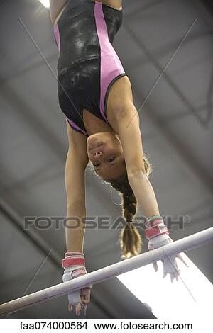 Picture - Female gymnast on horizontal bar. Fotosearch