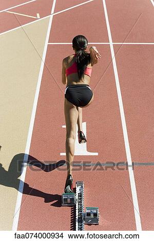 Female runner at starting line, rear view View Large Photo Image Picture - Female runner at starting line, rear view. Fotosearch