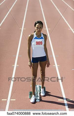 Female runner standing at starting line, portrait View Large Photo Image Stock Photo - Female runner standing at starting line, portrait. Fotosearch
