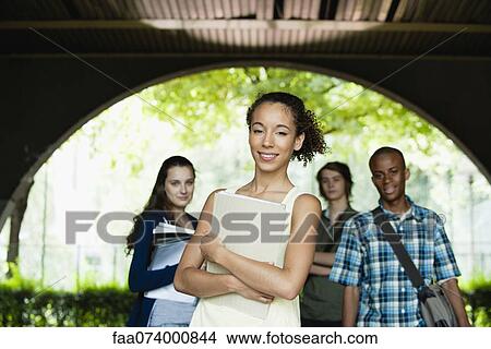 Picture - Female university student, friends in background. Fotosearch