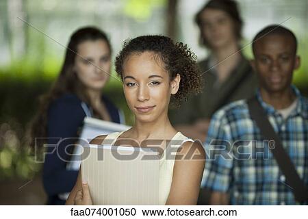Female university student, friends in background View Large Photo Image Stock Image - Female university student, friends in background. Fotosearch