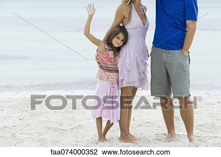 Girl and parents standing on beach, cropped View Large Photo Image Stock Image - Girl and parents standing on beach, cropped. Fotosearch