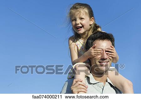 Girl covering father's eyes with her hands View Large Photo Image Stock Image - Girl covering father's eyes with her hands. Fotosearch