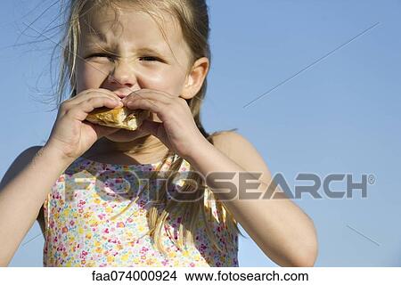 Girl eating sandwich outdoors View Large Photo Image Picture - Girl eating sandwich outdoors. Fotosearch