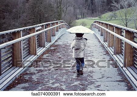 Girl walking on bridge with umbrella, rear view View Large Photo Image Stock Image - Girl walking on bridge with umbrella, rear view. Fotosearch