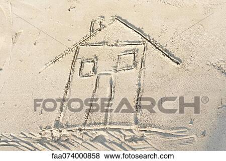 Stock Photo - House drawn in sand, high angle view. Fotosearch