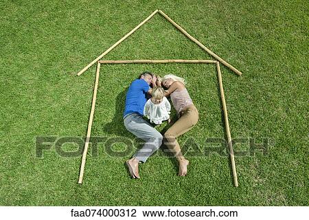 Stock Image - Little girl awake, parents sleeping, together within outline of house, high angle view. Fotosearch