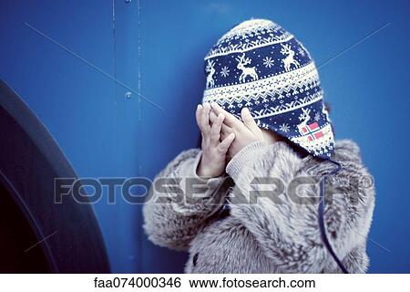 Stock Photograph - Little girl covering face with hands. Fotosearch