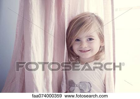 Little girl in front of window, smiling, portrait View Large Photo Image Stock Photo - Little girl in front of window, smiling, portrait. Fotosearch