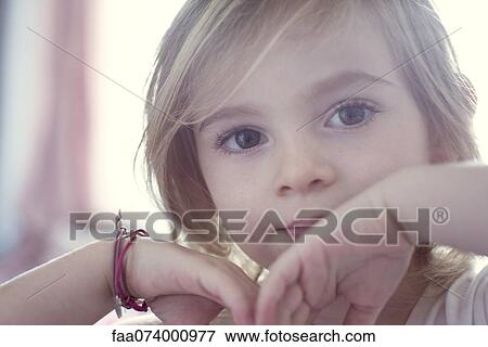 Stock Photo - Little girl looking at camera, portrait. Fotosearch