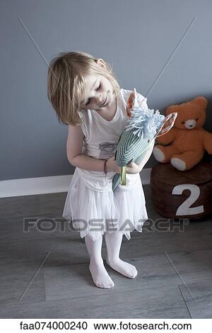 Little girl playing with hobby horse View Large Photo Image Stock Image - Little girl playing with hobby horse. Fotosearch
