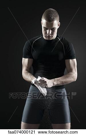Male athlete applying chalk to hands View Large Photo Image Stock Image - Male athlete applying chalk to hands. Fotosearch