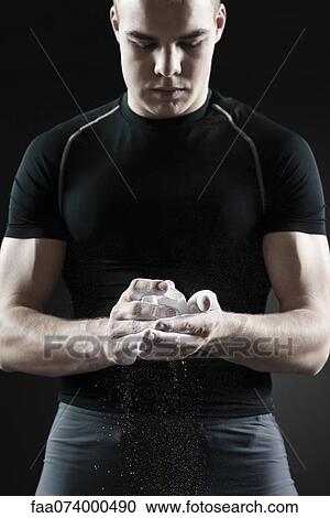 Male athlete applying chalk to hands View Large Photo Image Stock Image - Male athlete applying chalk to hands. Fotosearch