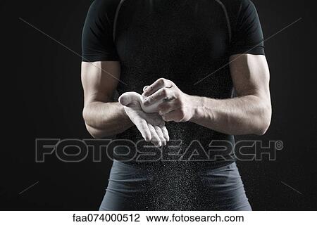 Male athlete applying chalk to hands, mid section View Large Photo Image Stock Image - Male athlete applying chalk to hands, mid section. Fotosearch