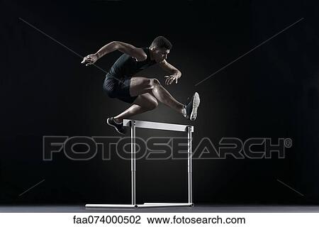 Male athlete clearing hurdle View Large Photo Image Stock Image - Male athlete clearing hurdle. Fotosearch