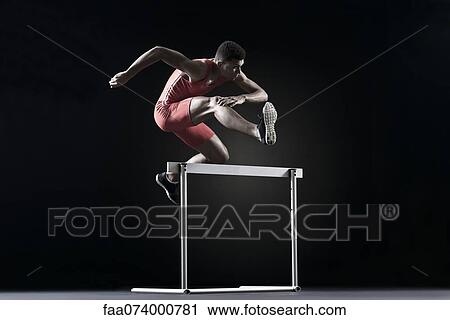 Male athlete clearing hurdle View Large Photo Image Stock Image - Male athlete clearing hurdle. Fotosearch