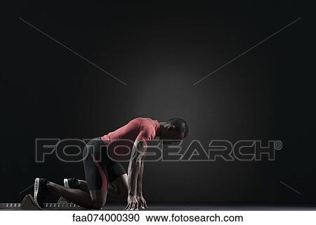 Male athlete on starting block View Large Photo Image Stock Image - Male athlete on starting block. Fotosearch