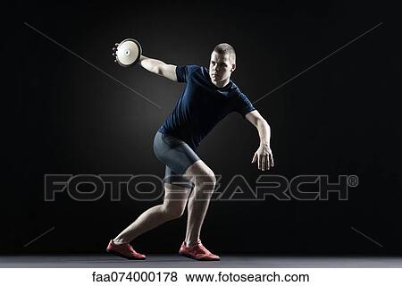 Stock Photo - Male athlete throwing discus. Fotosearch