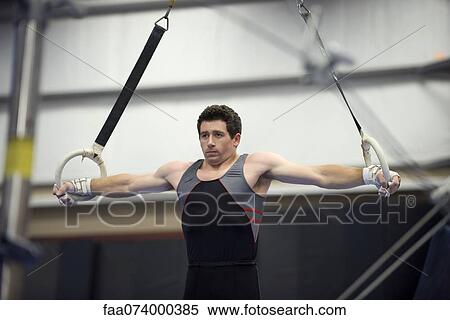 Stock Photography - Male gymnast on the rings. Fotosearch