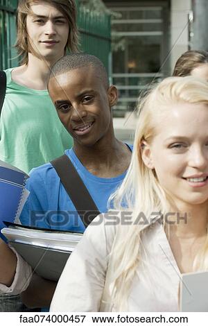 Stock Photo - Male university student among friends. Fotosearch