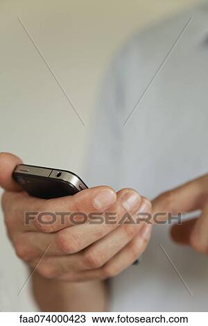 Man holding cell phone, cropped View Large Photo Image Stock Image - Man holding cell phone, cropped. Fotosearch