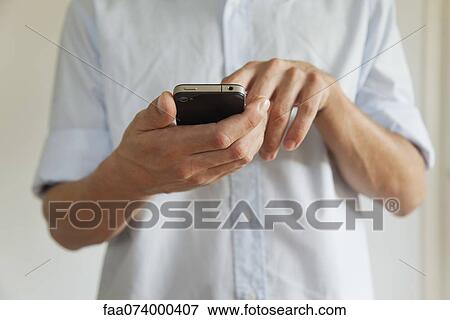 Man holding cell phone, cropped View Large Photo Image Stock Photo - Man holding cell phone, cropped. Fotosearch