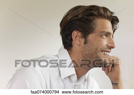 Picture - Man looking away, smiling. Fotosearch