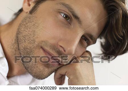 Man resting head on hand, daydreaming View Large Photo Image Stock Photo - Man resting head on hand, daydreaming. Fotosearch
