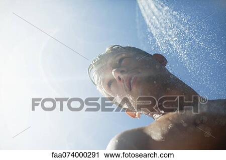 Man showering outdoors View Large Photo Image Stock Image - Man showering outdoors. Fotosearch