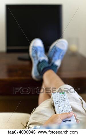 Stock Image - Man watching TV, cropped. Fotosearch
