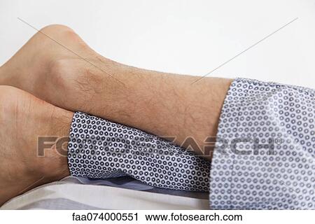 Man's leg's crossed at ankle View Large Photo Image Stock Image - Man's leg's crossed at ankle. Fotosearch