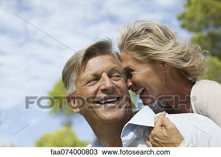 Mature couple nuzzling outdoors, portrait View Large Photo Image Stock Image - Mature couple nuzzling outdoors, portrait. Fotosearch