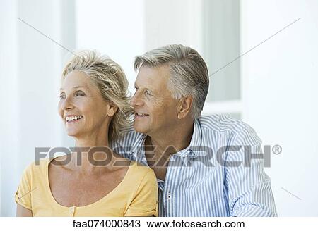 Mature couple relaxing together outdoors View Large Photo Image Stock Image - Mature couple relaxing together outdoors. Fotosearch