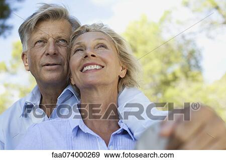 Mature couple relaxing together outdoors View Large Photo Image Stock Photo - Mature couple relaxing together outdoors. Fotosearch