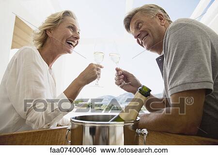 Mature couple toasting with champagne View Large Photo Image Stock Photograph - Mature couple toasting with champagne. Fotosearch