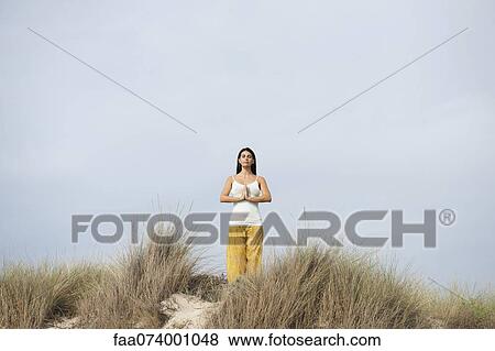 Stock Photo - Mature woman practicing yoga. Fotosearch