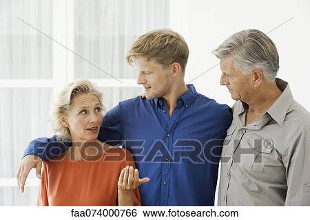 Mature woman talking with husband and adult son View Large Photo Image Stock Photograph - Mature woman talking with husband and adult son. Fotosearch