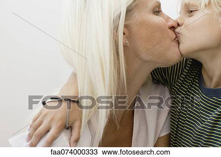 Mother kissing son View Large Photo Image Stock Image - Mother kissing son. Fotosearch